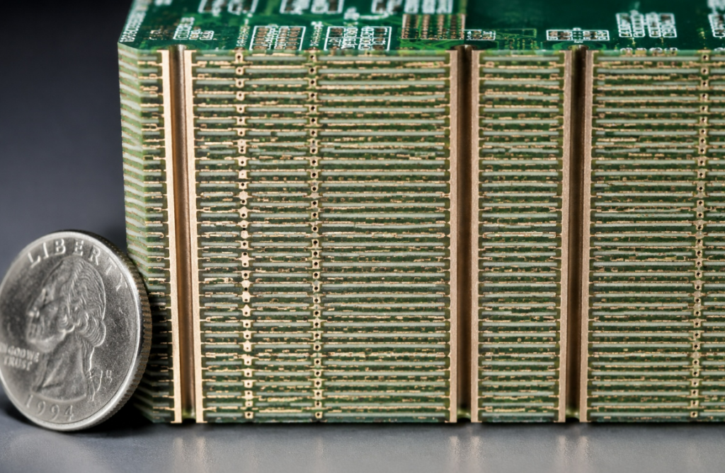 Macro view of an ultra-high layer count PCB cross-section showing 50 distinct layers of copper and dielectric.