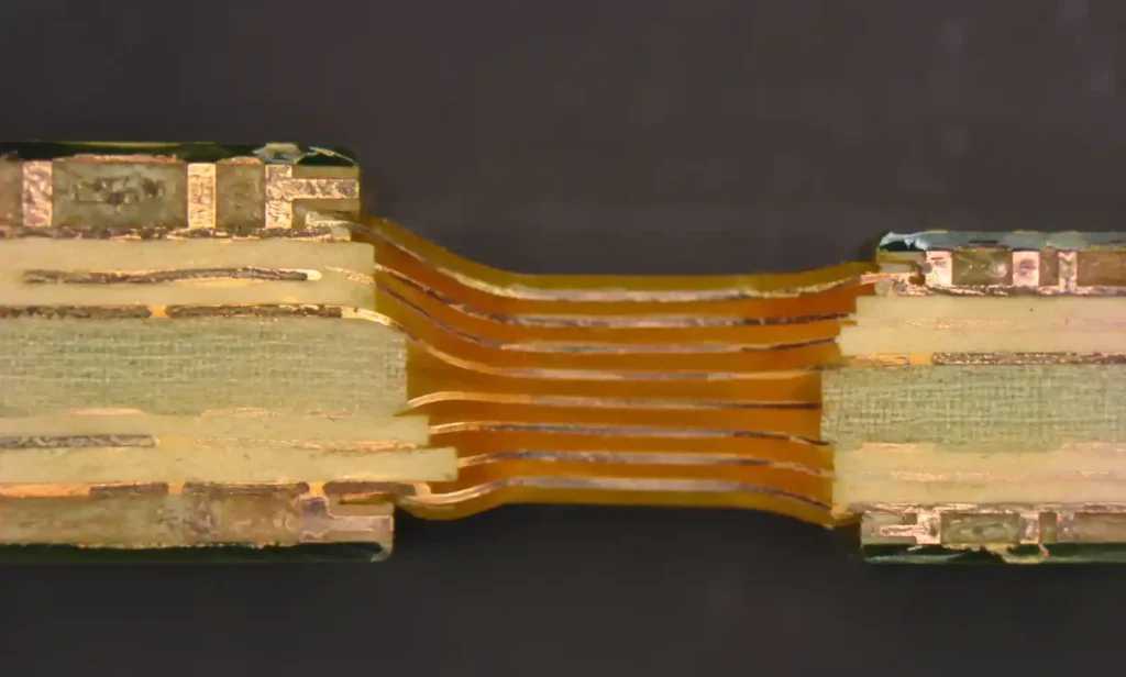 Cross-section view of rigid-flex PCB showing rigid sections with flexible circuit layers