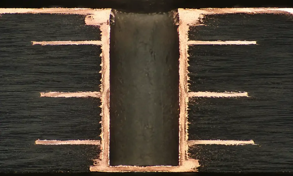 Plated through-hole cross-section showing copper barrel condition after thermal cycling