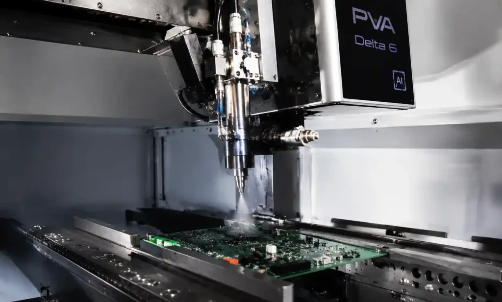 Selective robotic conformal coating machine spraying a precise pattern onto a PCB