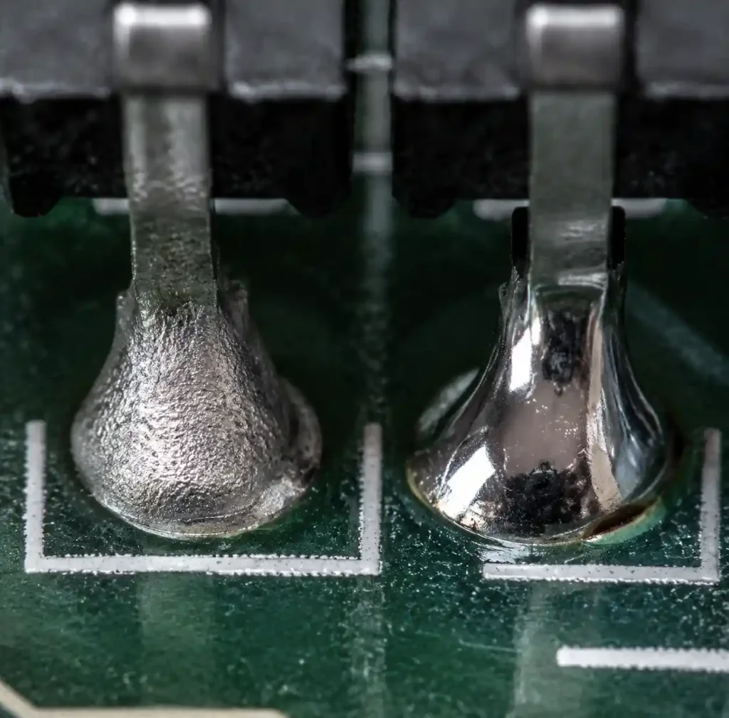 Cold solder joint showing dull grainy surface under magnification compared to proper shiny joint
