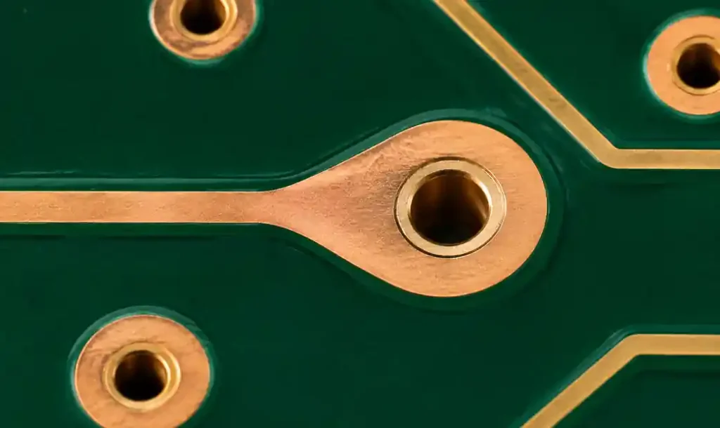 PCB teardrop copper fill at trace-to-via junction showing annular ring protection