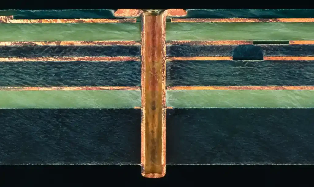 Via stub illustration in multilayer PCB showing unused copper barrel extending beyond signal layer connection