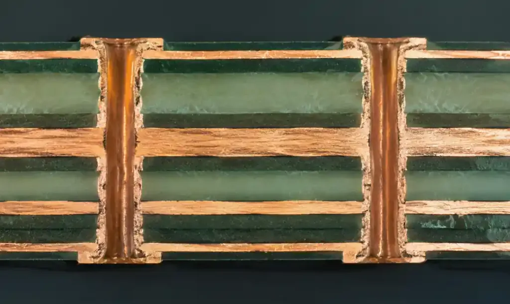 PCB microsectioning cross-section showing layer stackup and via structures under microscope